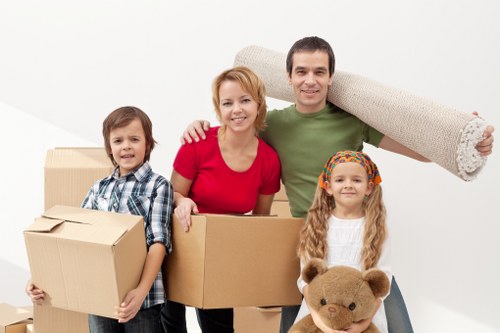 Local removals team handling furniture in a Brompton apartment building