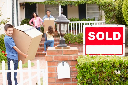 Packed moving van beside residential properties in Brompton