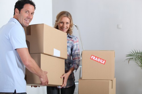 Organised office relocation process with desks, boxes, and IT equipment ready for transport